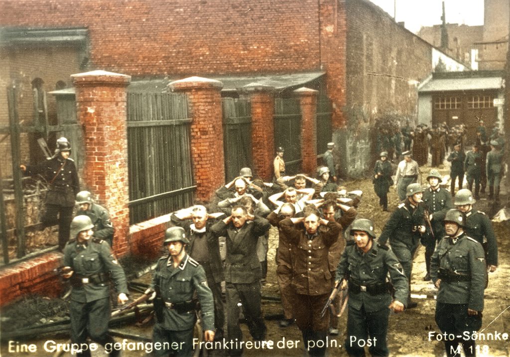 Niemieccy żołnierze prowadzą pojmanych obrońców poczty gdańskiej Fot. NAC